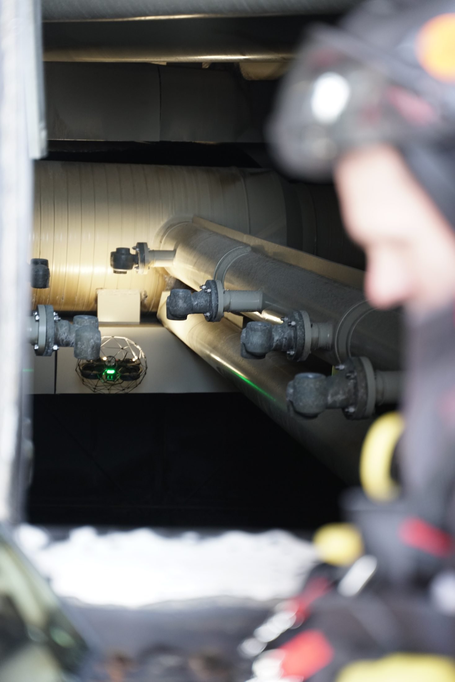 Caged drone flying between duct internals