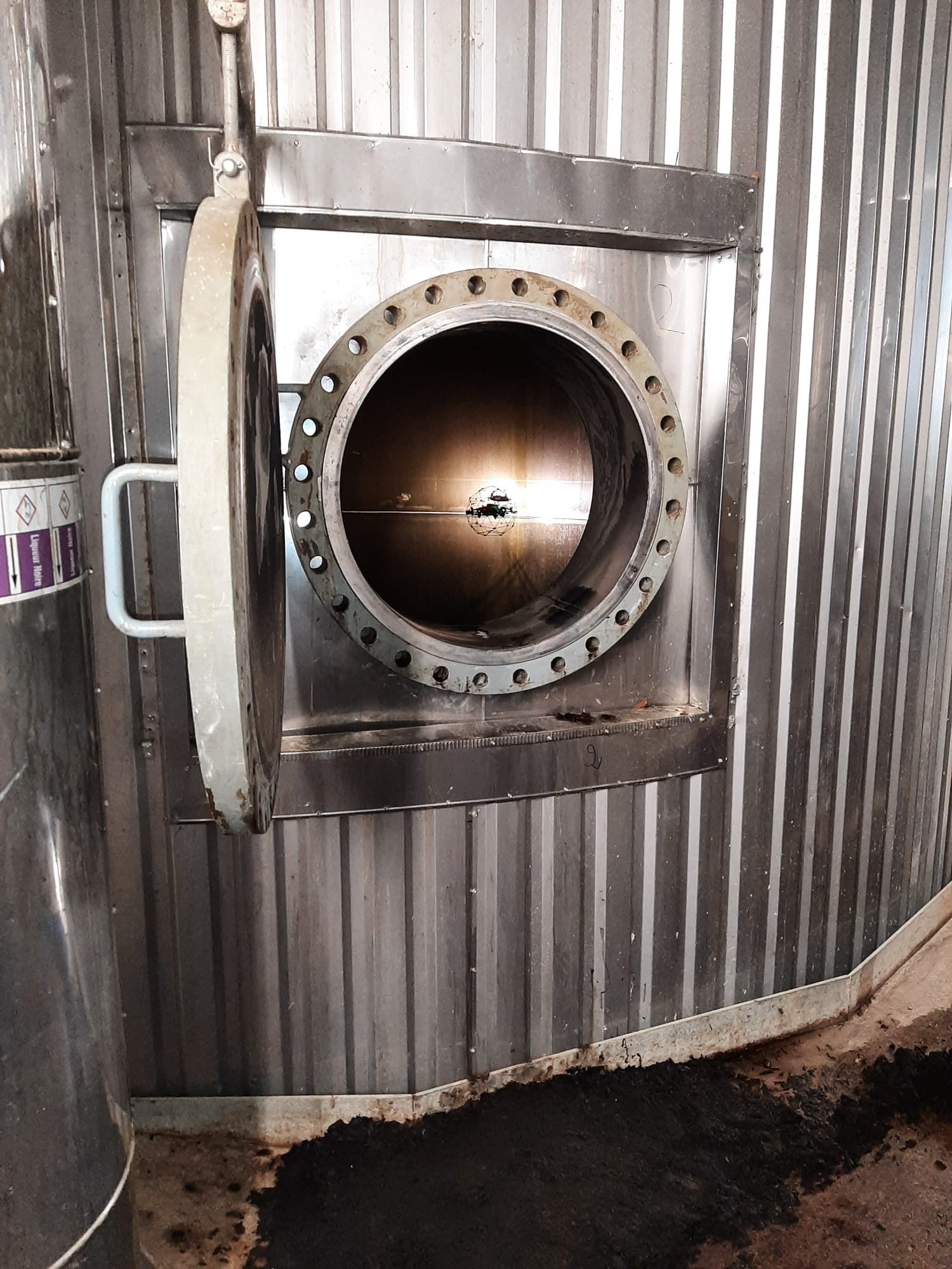 Drone entering a tank through a manhole
